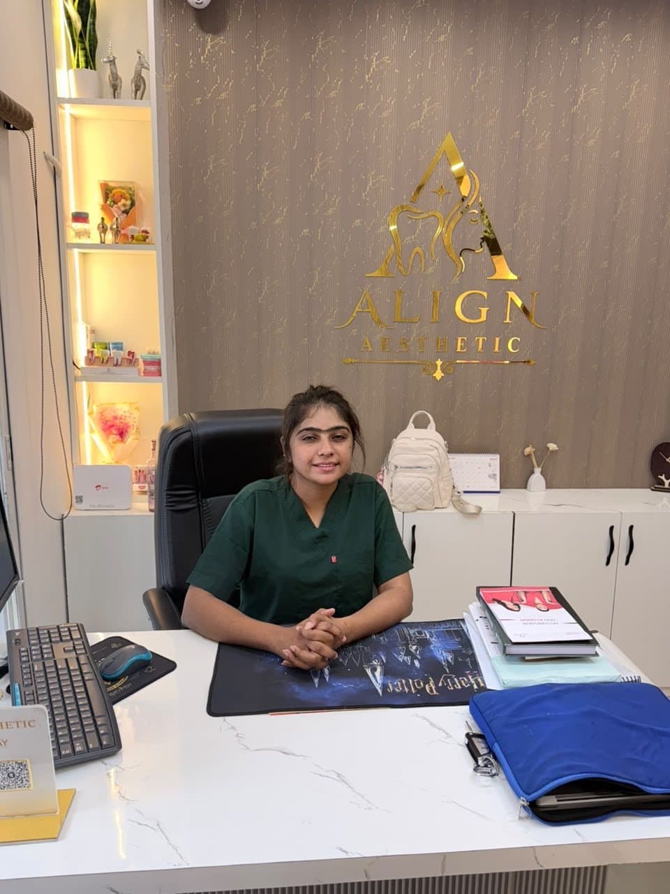 Dr. Nikita Soni at the consultation desk in scrubs