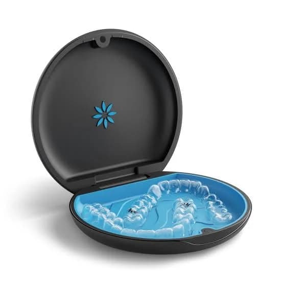 A set of clear aligner trays resting in their case